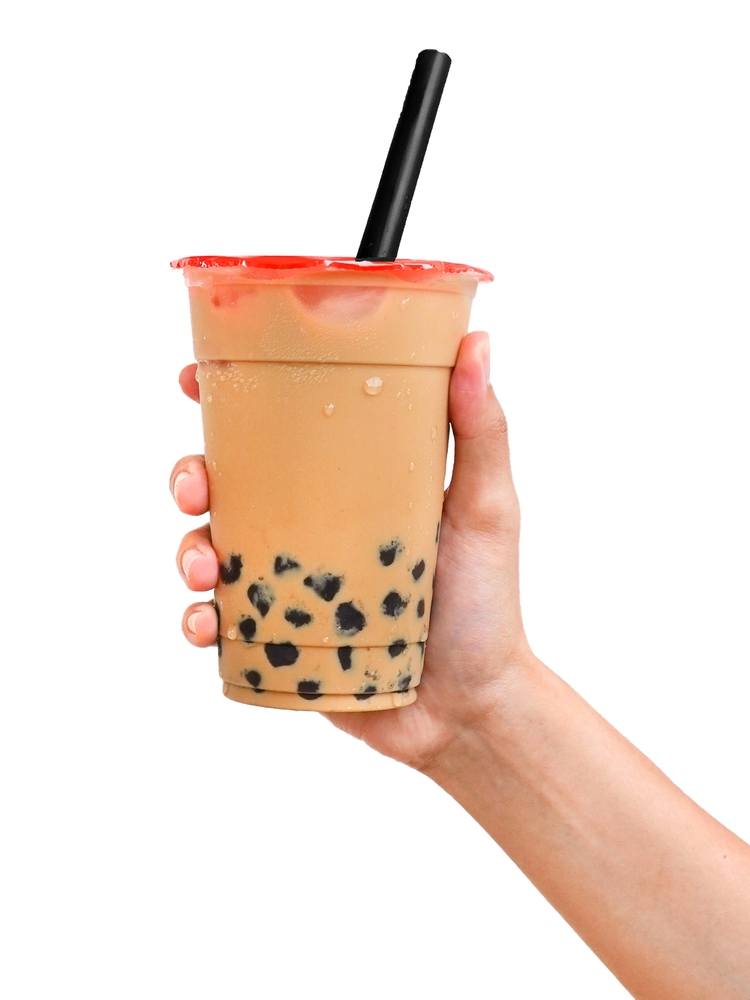 Image of a customer holding a cup of takeaway boba tea.